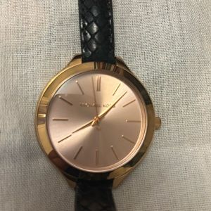 Rose Gold wrap watch with black leather band.